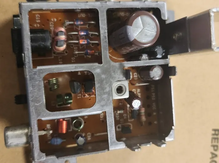 Small metal-shielded electronics module with capacitors and coils